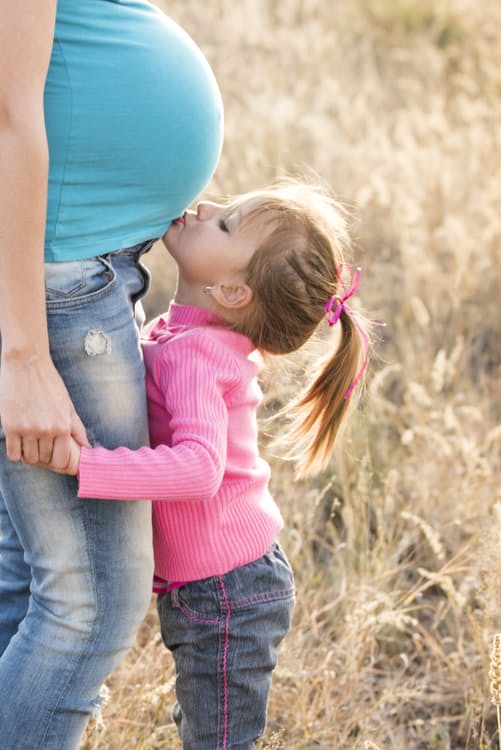 Little girl kissing her mother