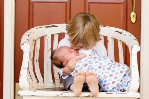 Older children taking care of it's sibling